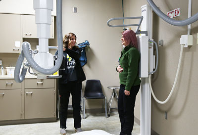 Radiology tech performing a scan on a femal patient.