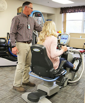 First picture: Therapist working with a patinet using bike equipment.
Second picture: Therapist working with a patient using Occupational Therapy.